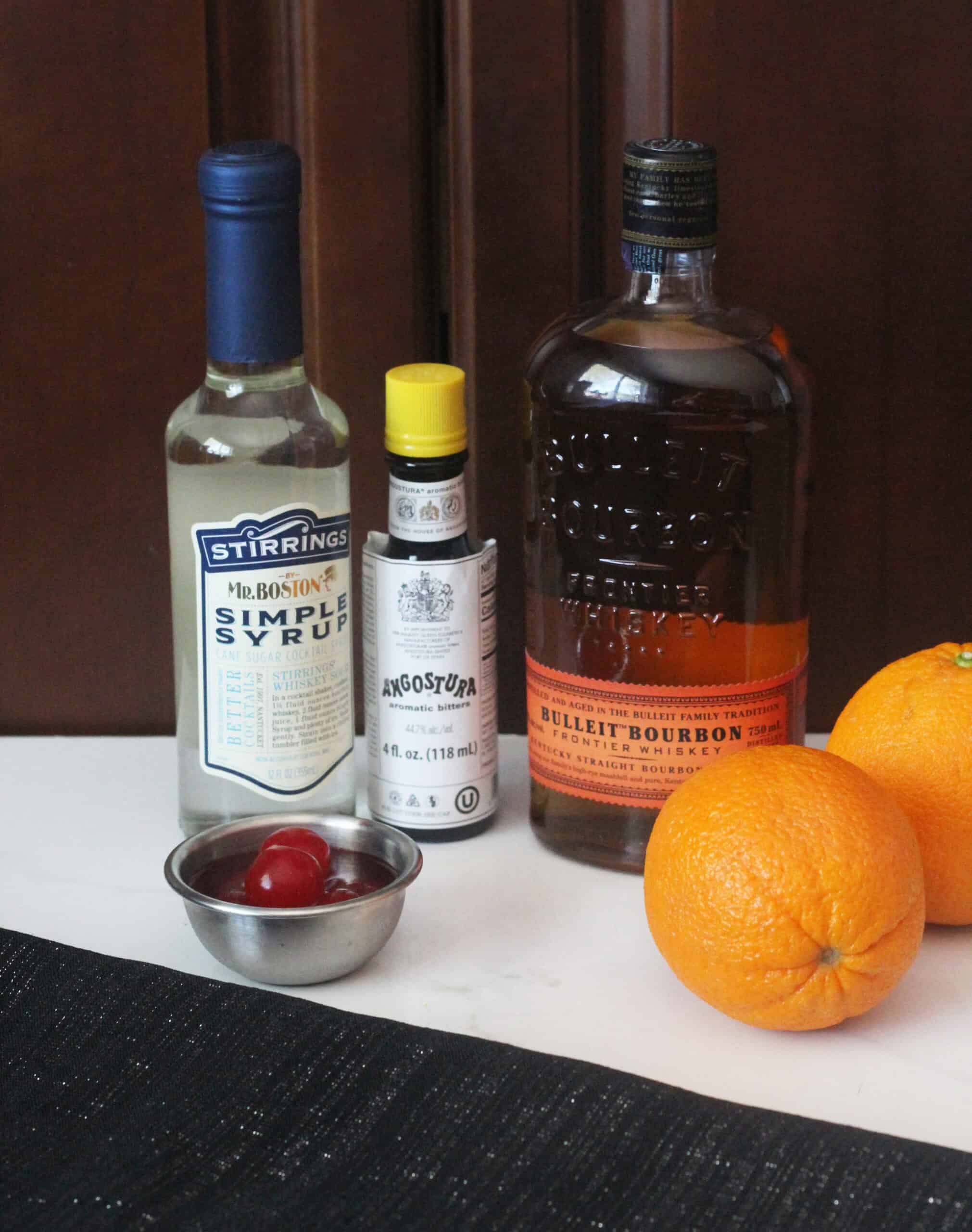 Ingredients: bourbon, bitters, simple syrup, oranges, cherries